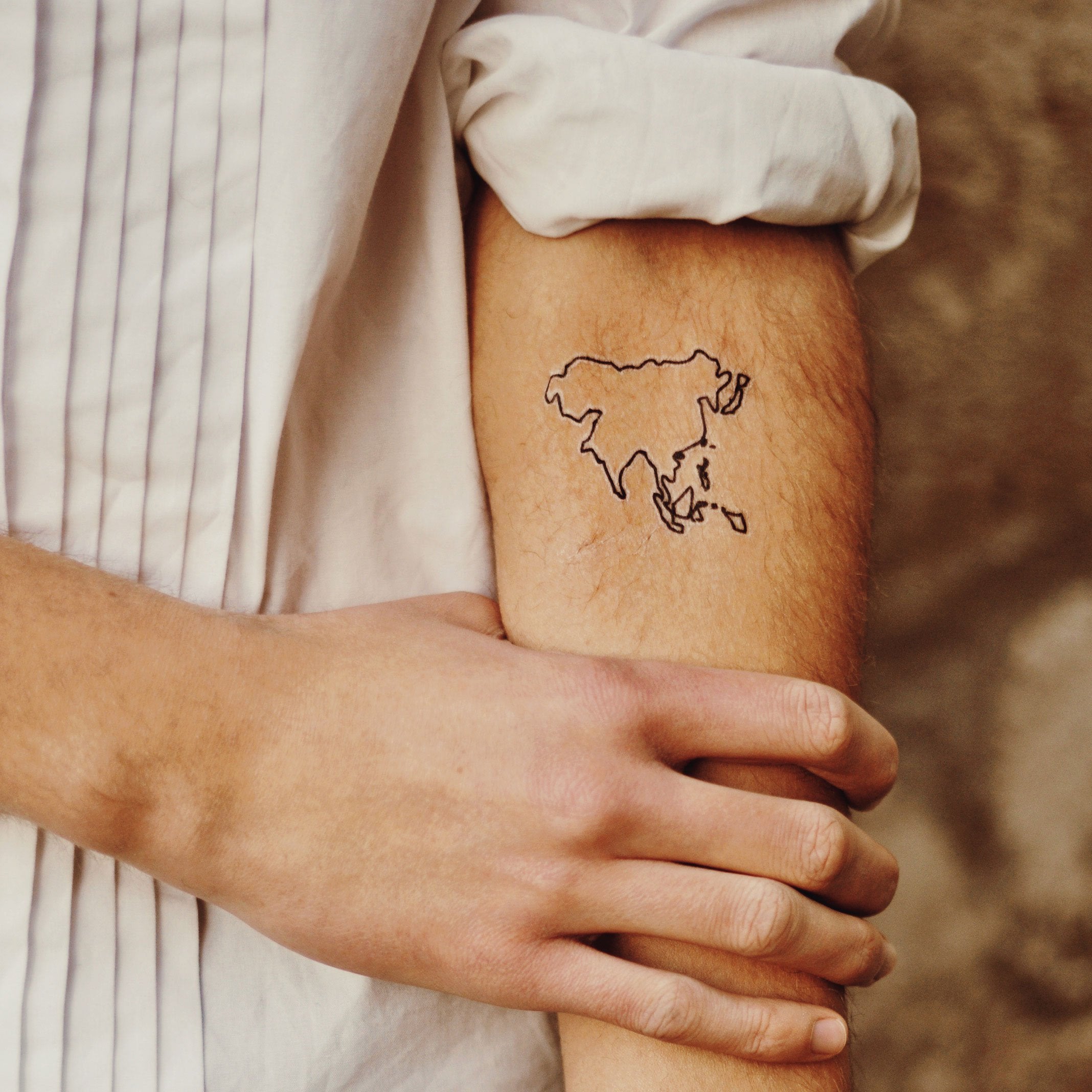 world map tattoo arm