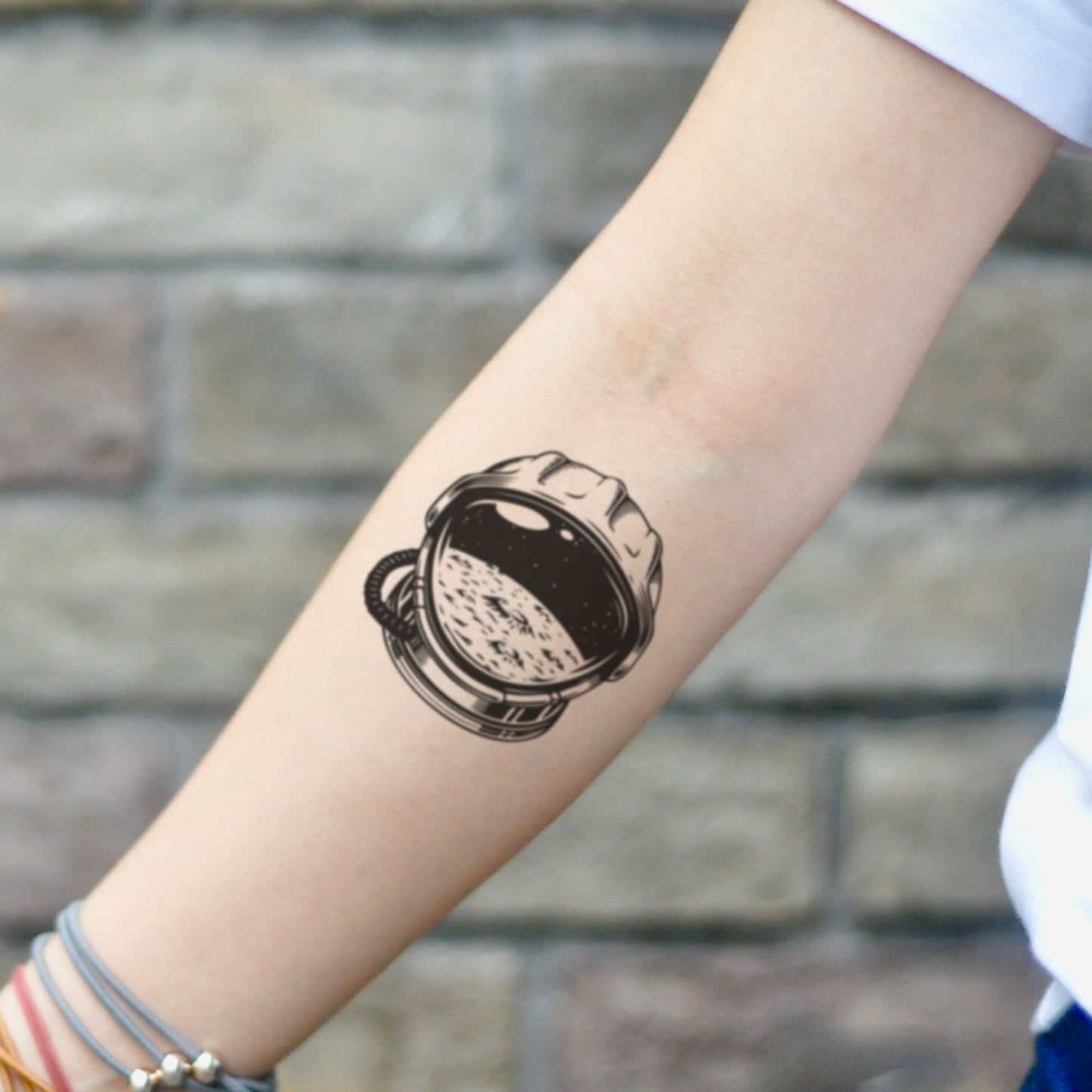 fake small astronaut helmet illustrative temporary tattoo sticker design idea on inner arm