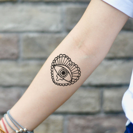 fake small crying heart and eye Illustrative temporary tattoo sticker design idea on inner arm