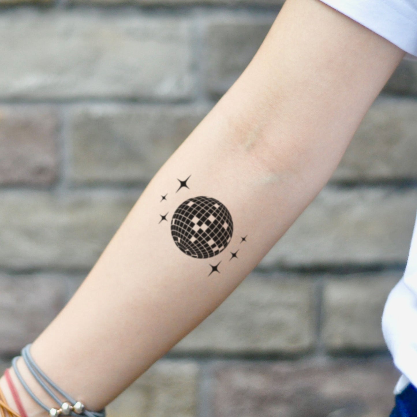 fake small disco ball Illustrative temporary tattoo sticker design idea on inner arm