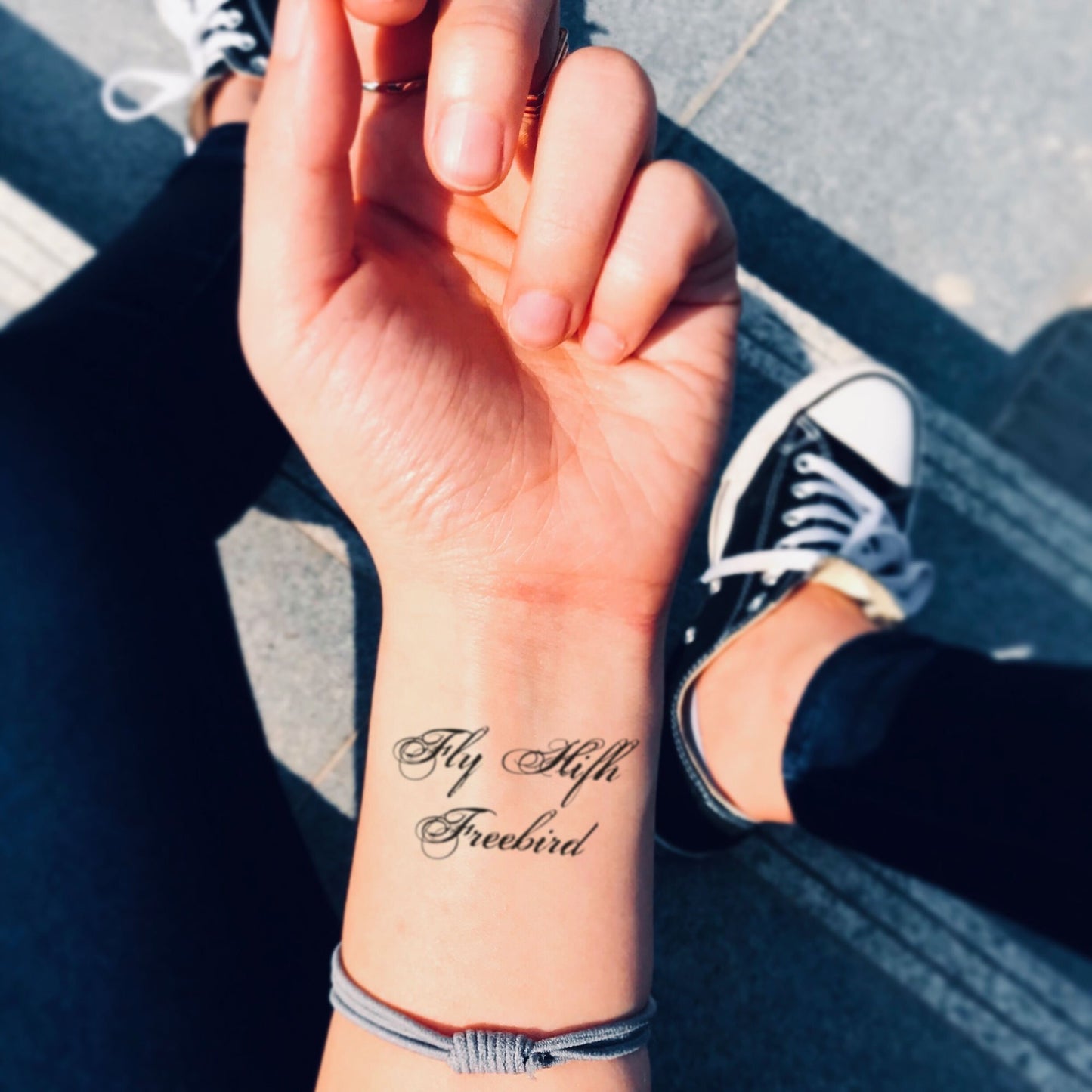 fake small fly high freebird lettering temporary tattoo sticker design idea on wrist