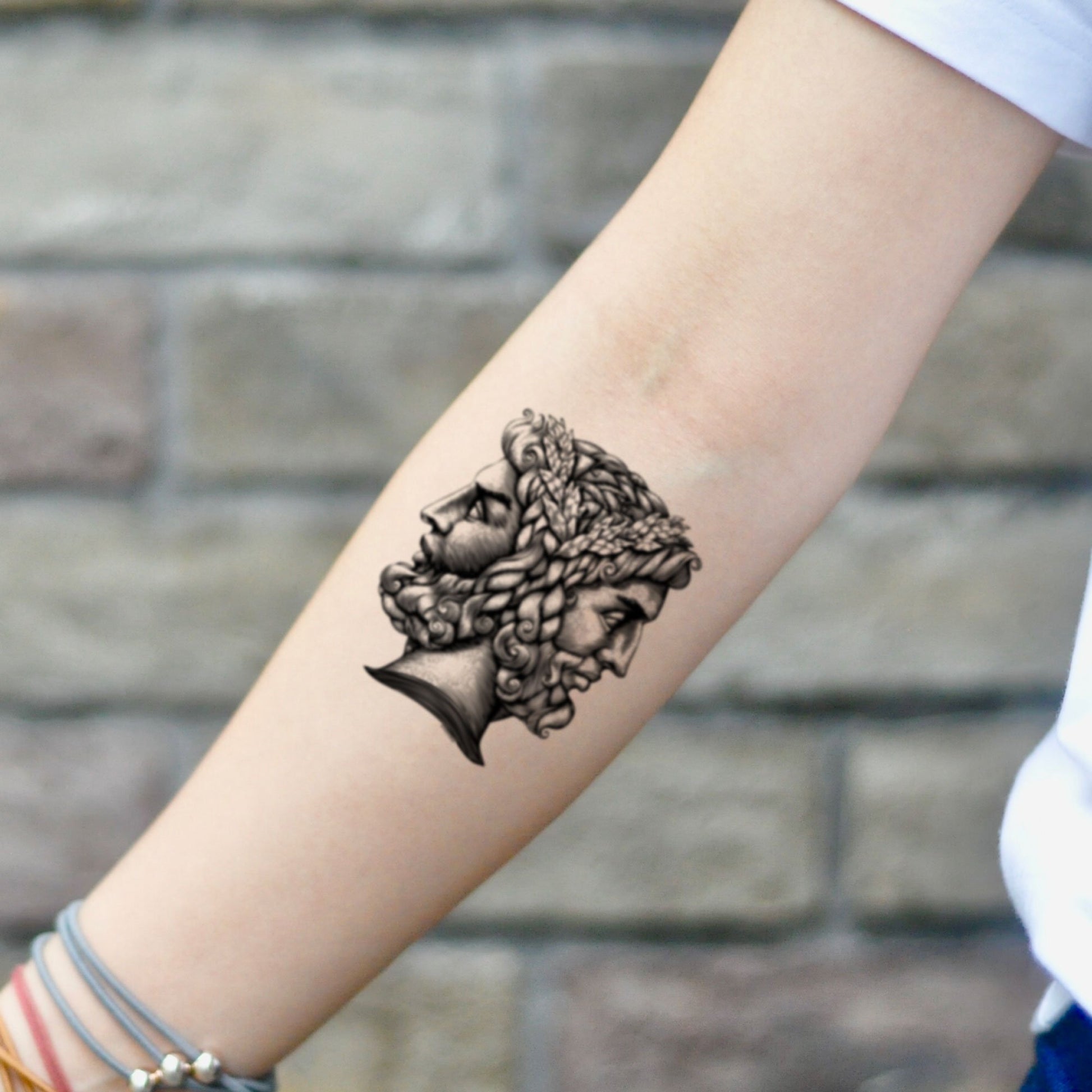 fake small janus god two faced illustrative temporary tattoo sticker design idea on inner arm