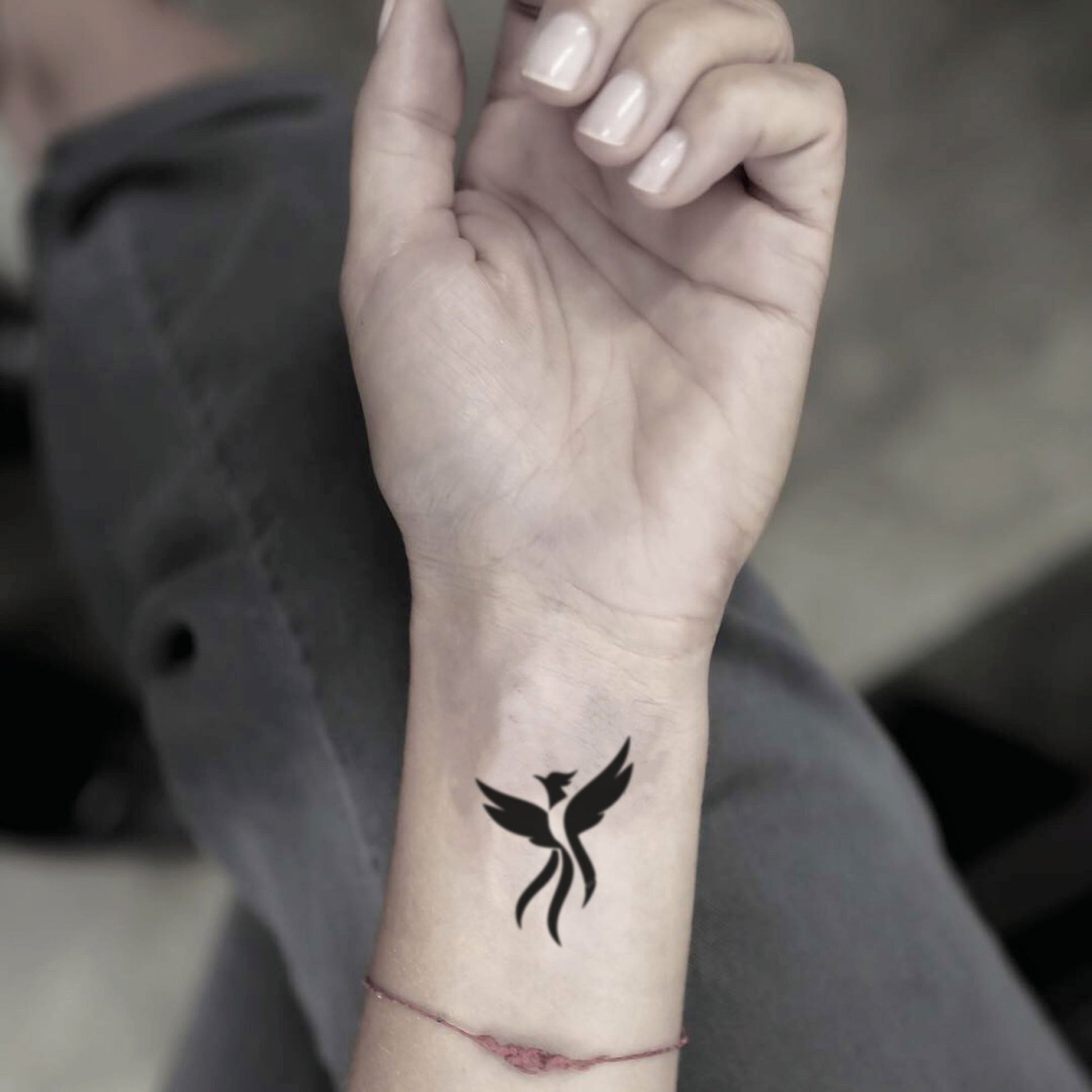 simple bird tattoo on wrist